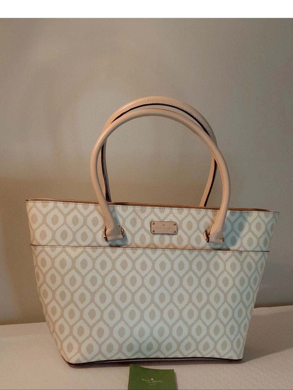 kate Spade cream patterned tote with beige trim.